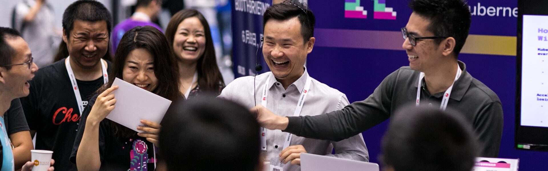 Group of people enjoying a demonstration at a booth