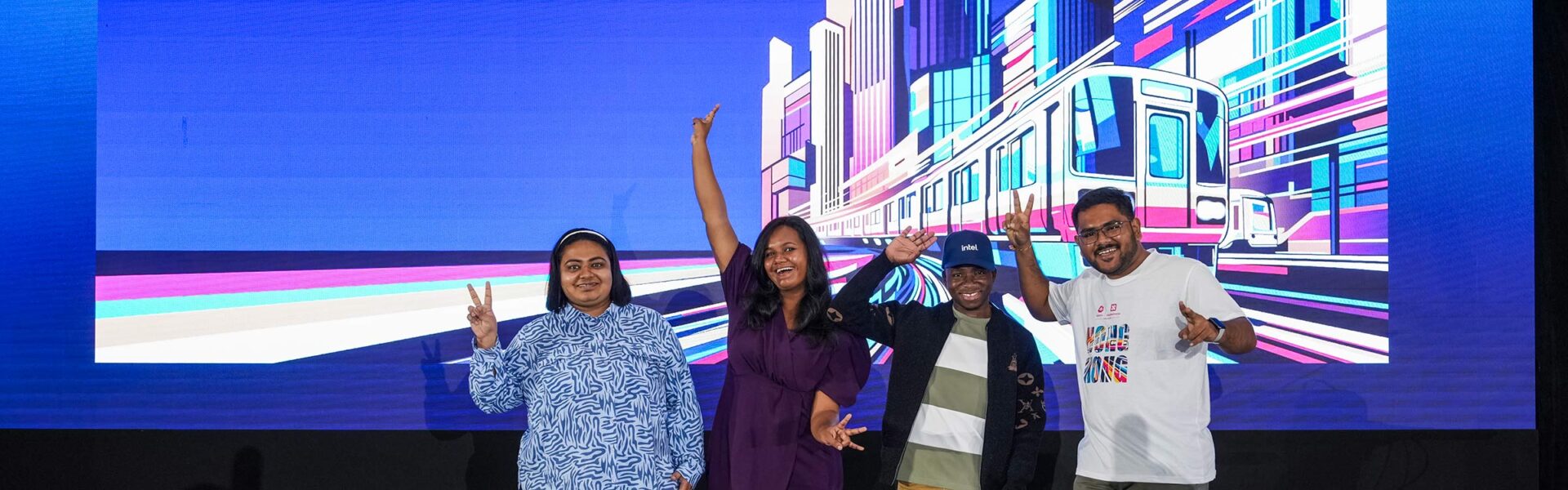Group of attendees posing and smiling on stage at a conference.
